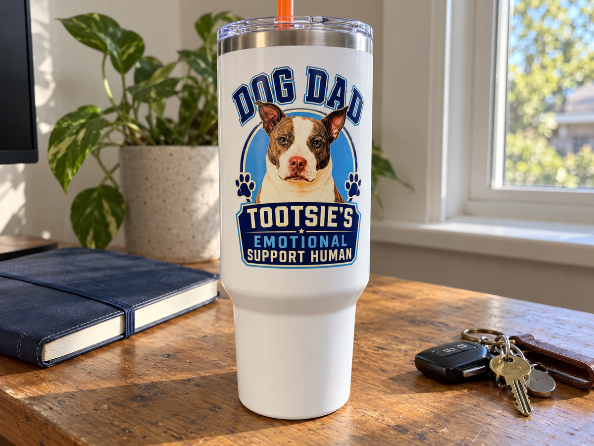 Lifestyle product mockup of personalized Dog Dad tumbler on a home desk
