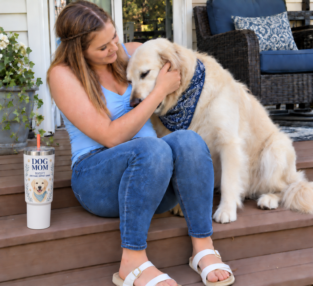 Approved lifestyle mockup of Morgan cuddling Bentley on porch beside personalized Dog Mom tumbler